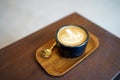Hot Latte - A cup of coffee with milk and beautiful leaf pattern latte art on wooden table and copy space, Perfect for breakfast Royalty Free Stock Photo