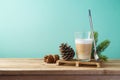 Hot Latte macchiato coffee cup on wooden table. Christmas menu