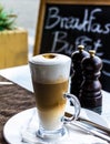 Hot latte macchiato coffee with tasty foam and cinnamon Royalty Free Stock Photo