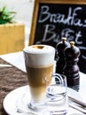 Hot latte macchiato coffee with tasty foam and cinnamon Royalty Free Stock Photo