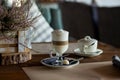 Hot latte macchiato coffee with tasty foam clear glass on dark wooden table serving with cookie,cane sugar. Coffee time Royalty Free Stock Photo