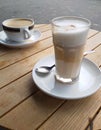 Hot latte macchiato and one cappuccino Royalty Free Stock Photo