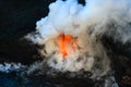 Hot lava hitting the cool Pacific Ocean causes steam and gases t