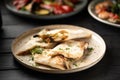 Hot lavash bread with melted suluguni cheese served on a white plate decorated with herbs Royalty Free Stock Photo