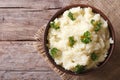 Hot mashed potatoes with parsley in a bowl close-up. top view