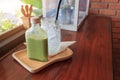 Hot matcha green tea in bottle and ice in glass on wood table. Royalty Free Stock Photo