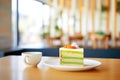 hot matcha latte with a slice of cake, caf setting