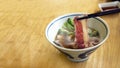 Hot meat boild with chopstick on noodle soup