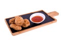 Hot Meat Dishes - Grilled Chicken Wings with Red Spicy Sauce. On a wooden board on a white background Royalty Free Stock Photo