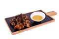 Hot Meat Dishes - Grilled Chicken Wings with Red Spicy Sauce. On a wooden board on a white background Royalty Free Stock Photo