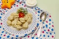 Hot meat dumplings with fresh sour cream. Homemade healthy kid`s food, funny toys Royalty Free Stock Photo