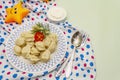 Hot meat dumplings with fresh sour cream. Homemade healthy kid`s food, funny toys Royalty Free Stock Photo