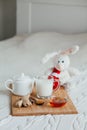 Hot milk in a glass cup and honey on wooden board. Treatment of children drink. folk remedies in bed. Soft toy Royalty Free Stock Photo