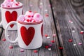 Hot milk with pink marshmallow in mugs with hearts for Valentine day Royalty Free Stock Photo