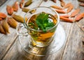 Hot mint tea in glass cup with atmospheric autumn decorations Royalty Free Stock Photo