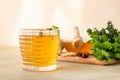 Hot mint and thyme tea with ginger root, lemon and honey, light concrete background. Herbal tea Royalty Free Stock Photo