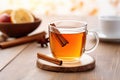 Hot mulled apple cider with with cinnamon sticks, cloves and anise on wooden table Royalty Free Stock Photo