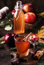 Hot mulled apple cider vinegar with cinnamon sticks, cloves and anise on wooden background. Traditional autumn, winter drinks and Royalty Free Stock Photo