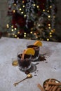 Hot mulled wine with orange, anise,cinnamon with fresh fruits on wooden table. Boceh light backgraund Royalty Free Stock Photo
