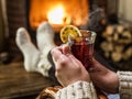 Hot mulled wine and book in woman hands. Relaxing in front of bu Royalty Free Stock Photo