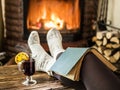 Hot mulled wine and book in woman hands. Royalty Free Stock Photo