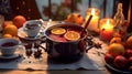 hot mulled wine cooked in two saucepan with spices, orange and cranberries on the table with Christmas fir twigs on a dark