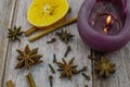 Hot mulled wine drink with lemon, apple, cinnamon, anise and other spices in a glass cup between fir tree branches on wooden Royalty Free Stock Photo