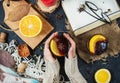 Hot mulled wine in female hands, spices on dark stone table. Sweet-home concept Royalty Free Stock Photo
