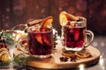 Hot mulled wine with spices in glass cup on wooden background. Traditional Christmas warming drink