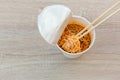Hot noodle Cup. Noodle cup Ready made. Eating Instant Noodles with a Plastic Fork. Junk food Instant noodles are eating the popula Royalty Free Stock Photo
