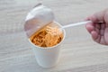 Hot noodle Cup. Noodle cup Ready made. Eating Instant Noodles with a Plastic Fork. Junk food Instant noodles are eating the popula Royalty Free Stock Photo