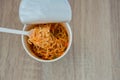 Hot noodle Cup. Noodle cup Ready made. Eating Instant Noodles with a Plastic Fork. Junk food Instant noodles are eating the popula Royalty Free Stock Photo