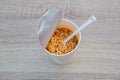 Hot noodle Cup. Noodle cup Ready made. Eating Instant Noodles with a Plastic Fork. Junk food Instant noodles are eating the popula Royalty Free Stock Photo