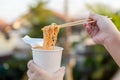 Hot noodle Cup. Noodle cup Ready made. Eating Instant Noodles with a Plastic Fork. Junk food Instant noodles are eating the popula Royalty Free Stock Photo