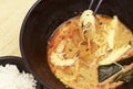 Hot noodles with shrimps top view, wooden background, close-up