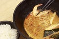 Hot noodles with shrimps top view, wooden background, close-up