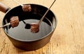 Hot Oil Fondue with Cubes of Cooked Beef on Forks Royalty Free Stock Photo