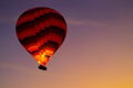 Hot one air balloons at sunset in Goreme village, Cappadocia, Turkey red and blue Royalty Free Stock Photo