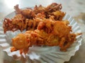 Hot onion bhajjiya bhajiya Indian fast food street food with green pudina chutney on paper plate ready to eat yummy tastey food Royalty Free Stock Photo