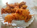 Hot onion bhajjiya bhajiya Indian fast food street food with green pudina chutney on paper plate ready to eat yummy tastey food