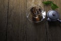 Hot organic teacup with kettle and green tea leaf on wooden table background. Royalty Free Stock Photo