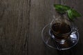 Hot organic teacup with spoon and green tea leaf on wooden table background. Healthy herbal drink for morning makes you feel refre Royalty Free Stock Photo