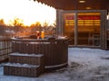 Hot outdoor wooden bath tub on terrace of private house. Finnish sauna Royalty Free Stock Photo