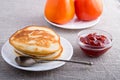 Hot pancakes, strawberry jam and tomatoes close-up Royalty Free Stock Photo
