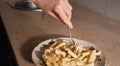 Hot pasta in a plate and a hand with a fork in the kitchen. Image for your creative decoration