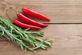 Hot pepper and rosemary on a wooden background