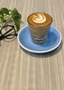 Hot piccolo Latte on blue plate