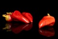 Hot pickled pepper isolated on black glass Royalty Free Stock Photo