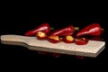 Hot pickled pepper isolated on black glass Royalty Free Stock Photo