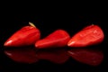 Hot pickled pepper isolated on black glass Royalty Free Stock Photo